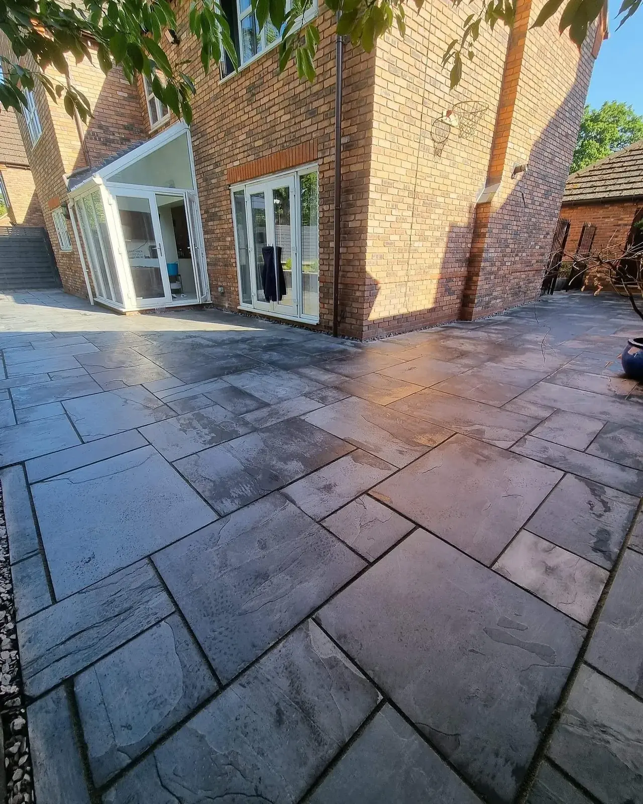 Freshly jet washed slate patio behind a Solihull house