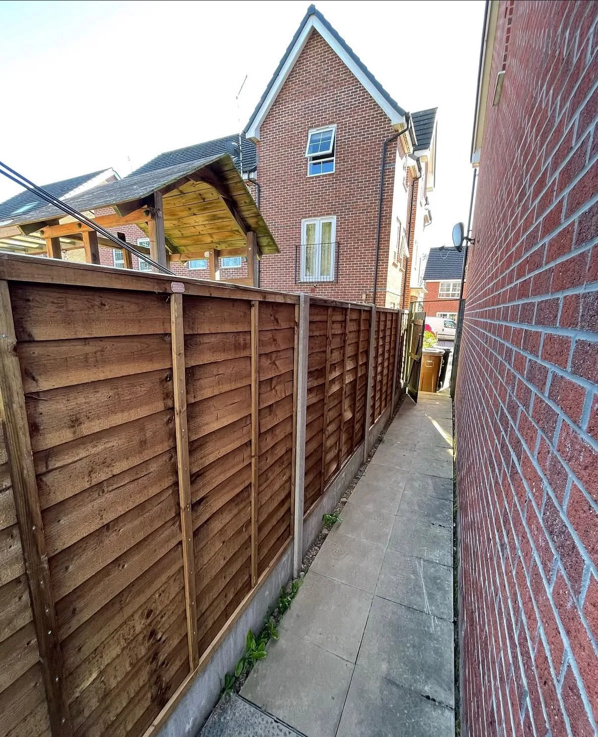 New overlap panel fencing with concrete posts along a side path in Solihull