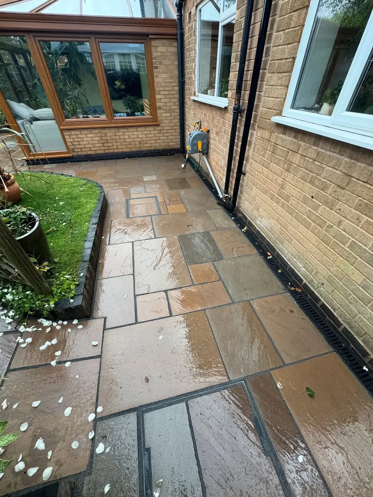 Natural sandstone side patio with drainage channel in Solihull