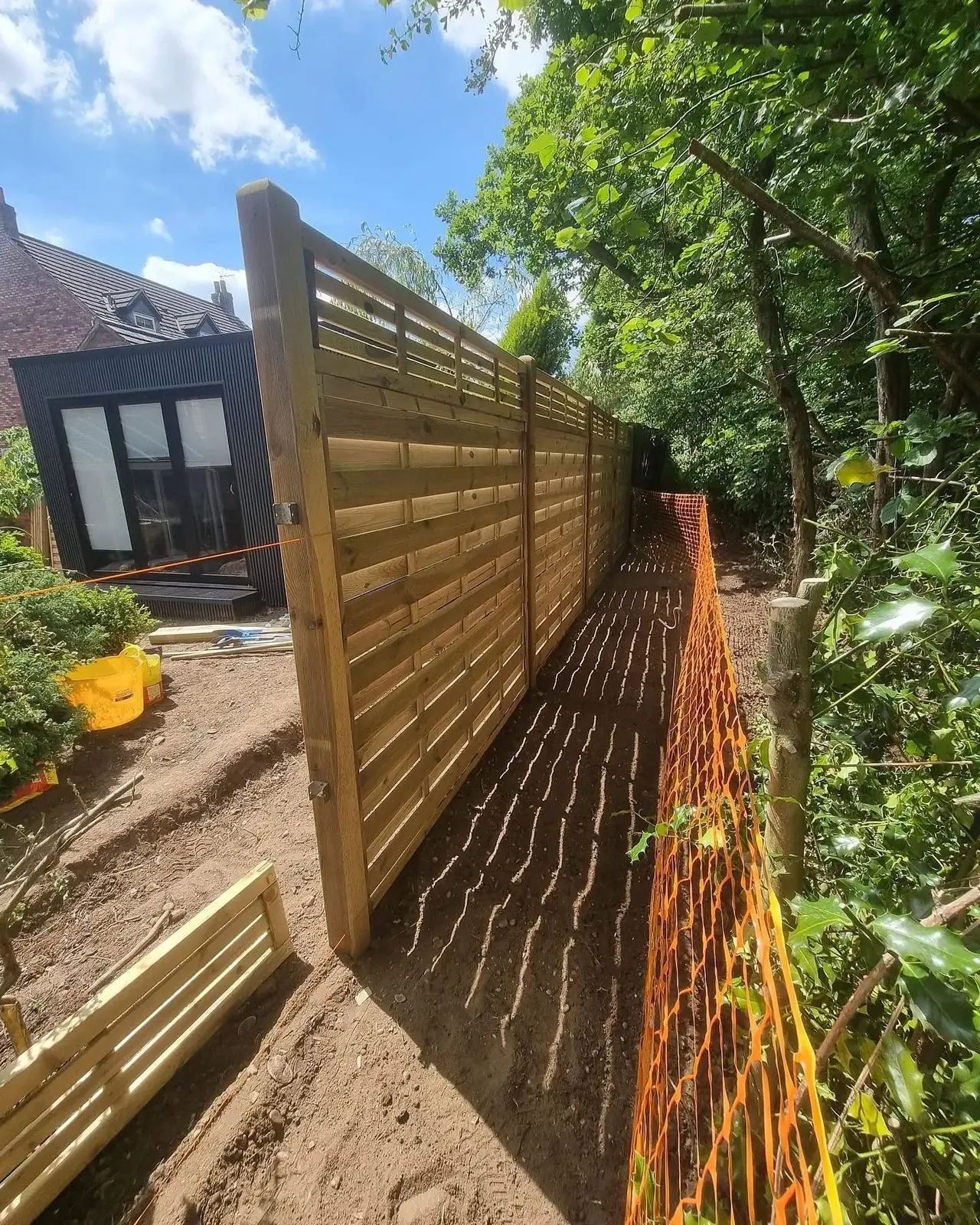 New horizontal slatted timber fence installation in a Solihull garden