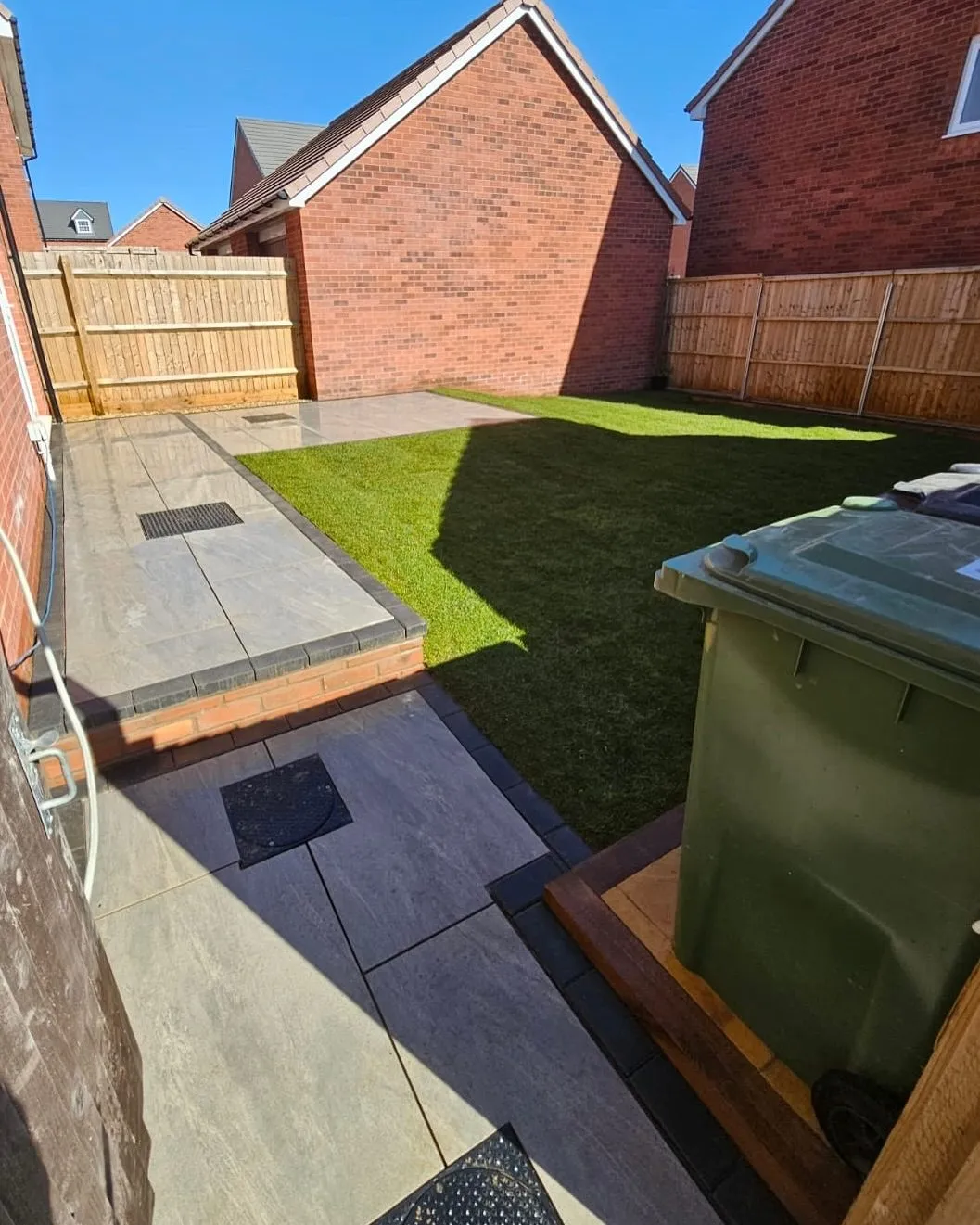 New turf lawn laid beside a patio in a Solihull new-build garden