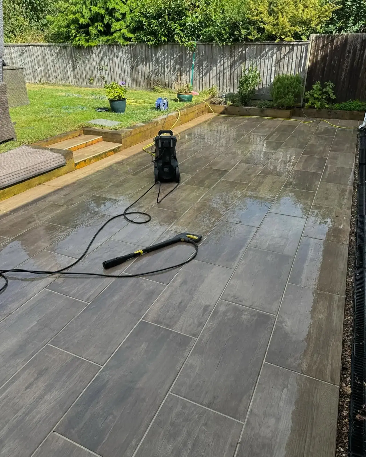 Patio jet washing with a pressure washer in a Solihull garden