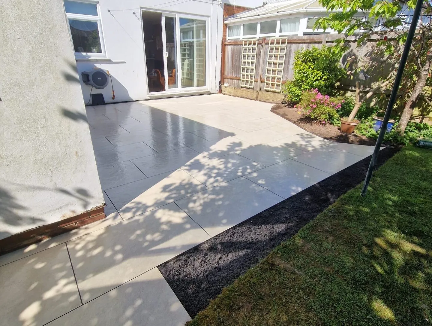 Light porcelain patio laid along the back of a Solihull house